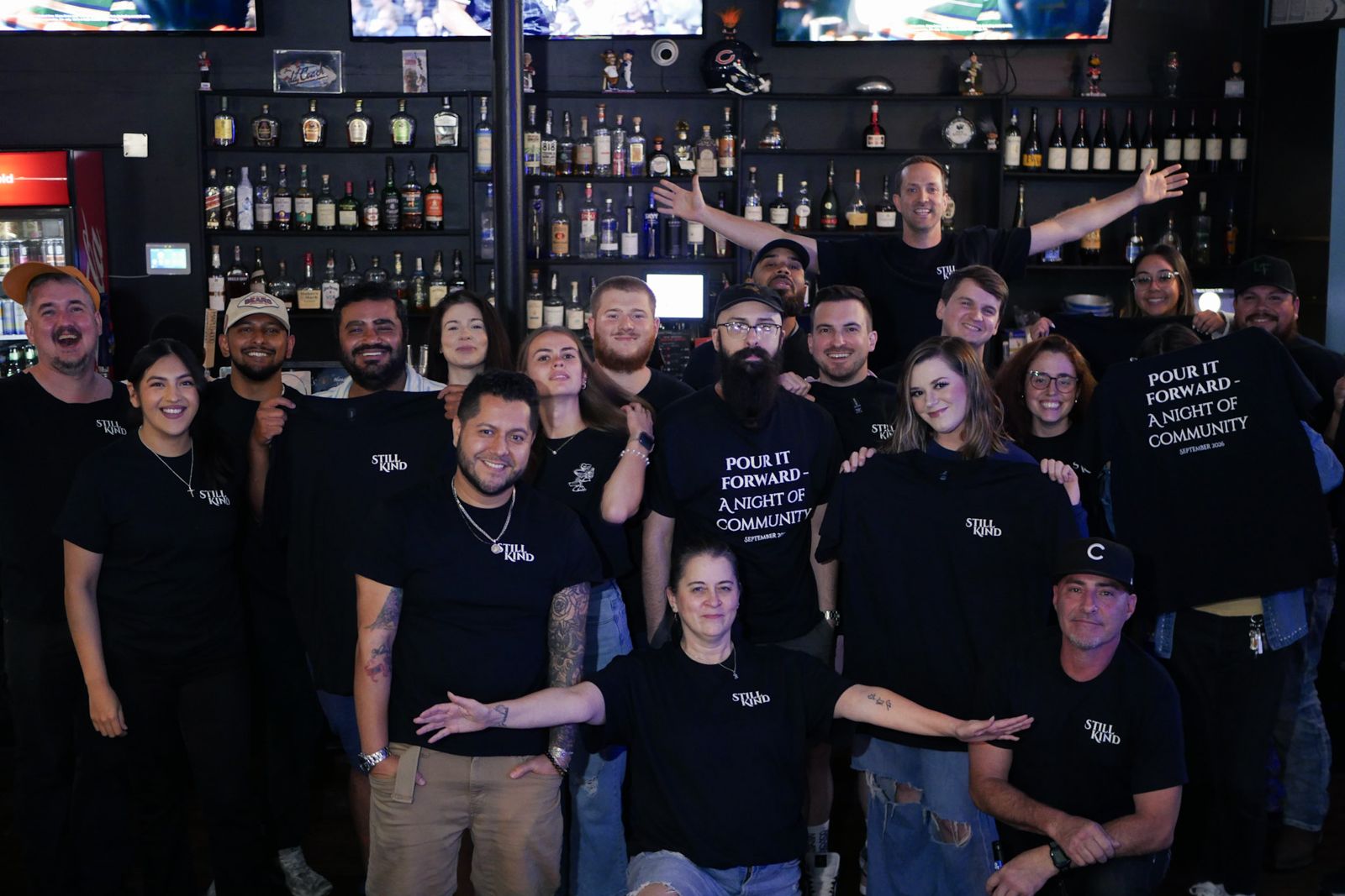 The Still Kind crew and guests in Pour It Forward shirts at Primetime Bar and Grill